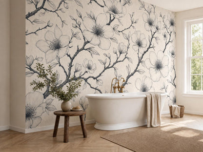 The blossom wallpaper across a bathroom wall beside a window, with a white tub and a jute rug