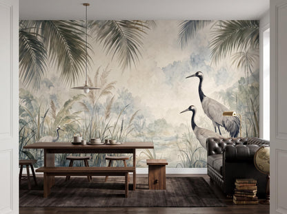 Watercolour crane marsh mural behind a wooden dining table, bench and dark leather sofa