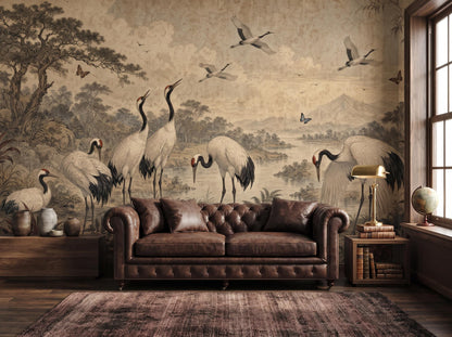Muted burgundy crane woodland mural behind a brown leather chesterfield sofa and a brass lamp