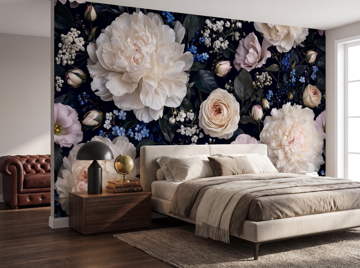 The dark peony wallpaper across a bedroom wall, with a linen bed and an oxblood chesterfield