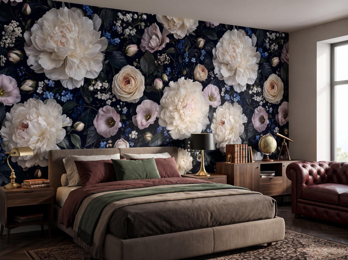 Close view of the peonies, roses and blue forget-me-nots above a bed and bedside lamp
