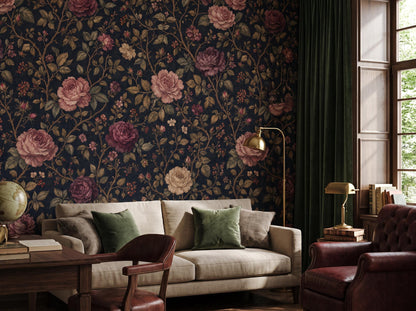 The rose wallpaper beside a tall window, with a pale sofa and an oxblood leather armchair