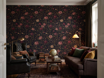 Wide room with the dark rose wallpaper, a leather sofa, stacked books and a globe