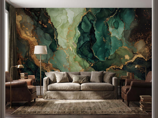 Emerald green marble mural with gold veining behind a linen sofa, framed by leather armchairs and stacked books