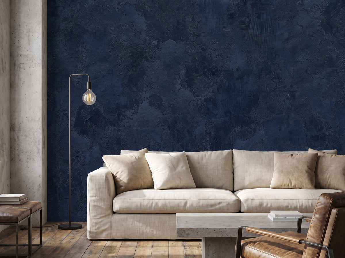 Navy blue limewash mural across a wide wall beside a concrete column, with a linen sofa and a floor lamp