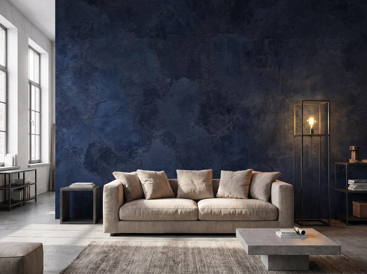 Navy blue plaster mural filling a wall beside a tall window, with a linen sofa and a brass floor lamp