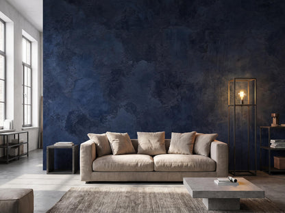 Navy blue plaster mural filling a wall beside a tall window, with a linen sofa and a brass floor lamp