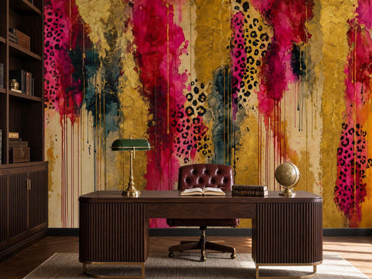 Gold and magenta abstract wallpaper behind a dark wood desk with a green banker's lamp, globe and bookcase