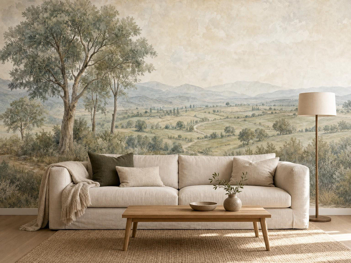 Warm grey countryside mural behind a cream sofa with olive cushions and a wooden coffee table