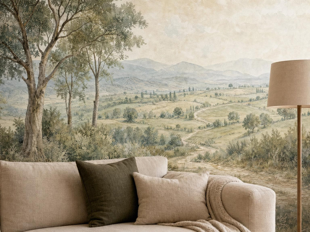 Close view of the trees, fields and distant hills in the countryside mural, above a cream sofa