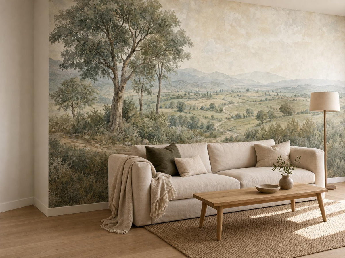 The countryside mural on a side wall, with a long cream sofa and an oak coffee table