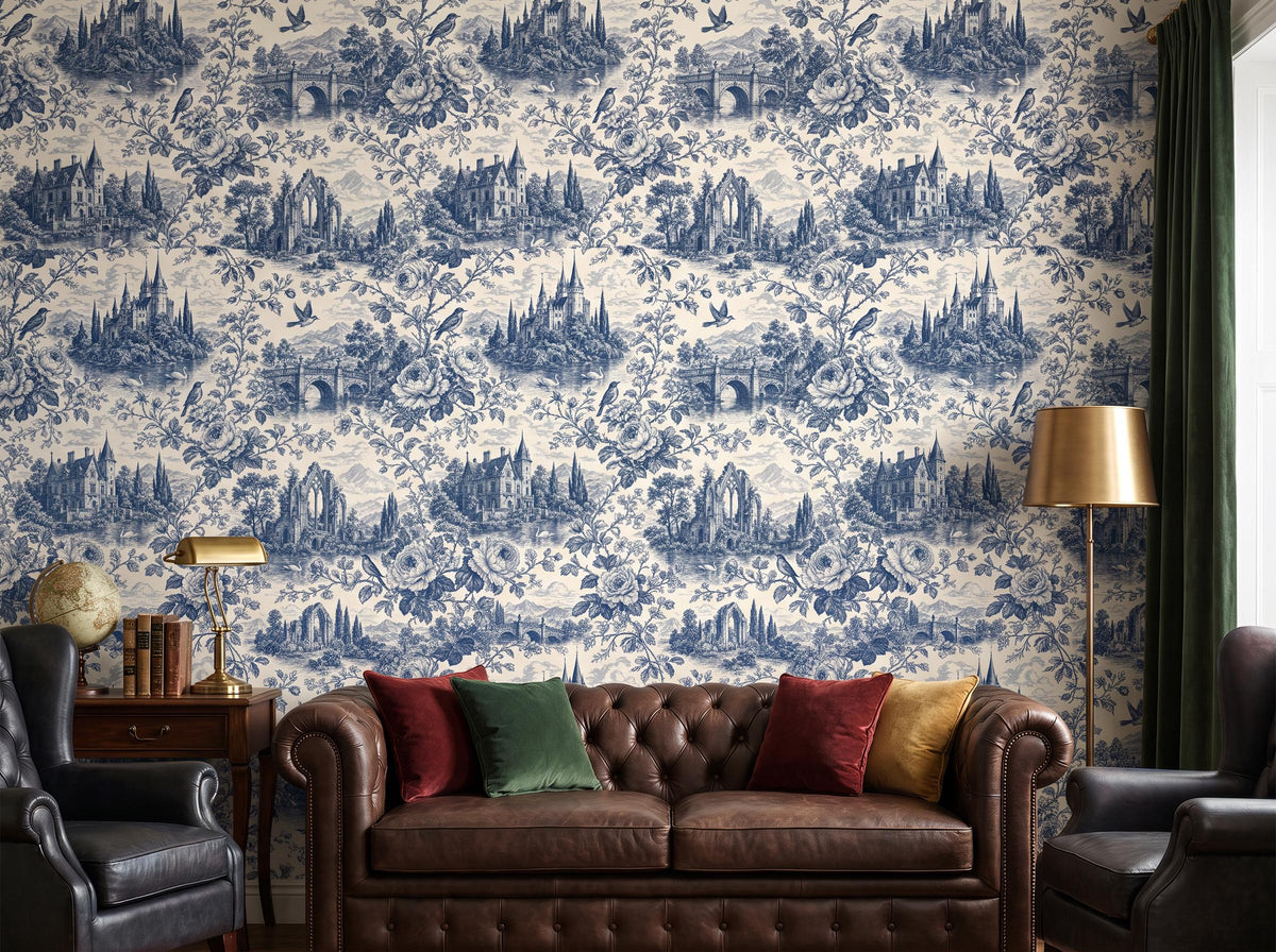Blue and cream toile wallpaper behind a brown leather chesterfield sofa with jewel-toned cushions