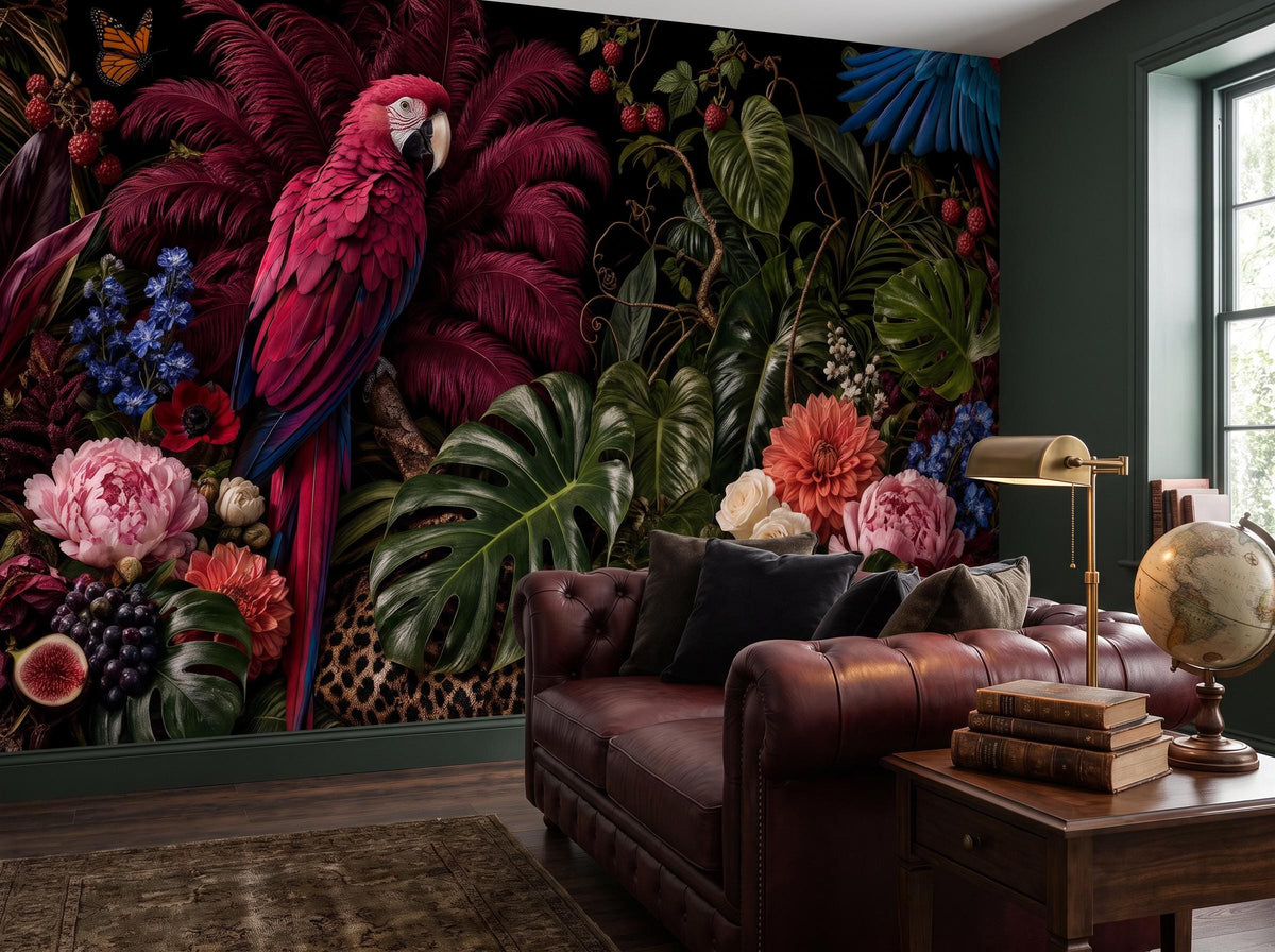 Close view of the macaw, monstera leaves and coral dahlias beside a leather sofa and brass lamp