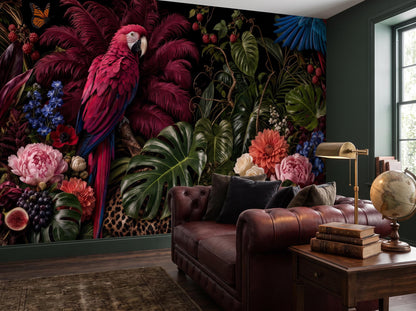 Close view of the macaw, monstera leaves and coral dahlias beside a leather sofa and brass lamp